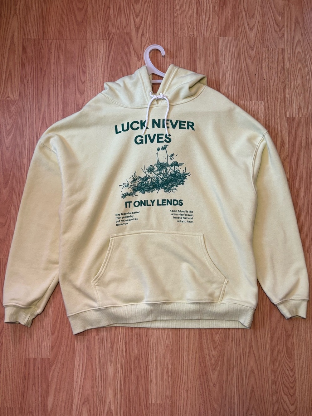 Yellow Graphic Hoodie with 'Luck Never Gives' Print